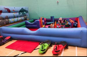 Blue inflatable soft play surround with shapes and hoppys